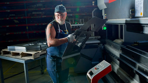 Allmand employee working in the factory